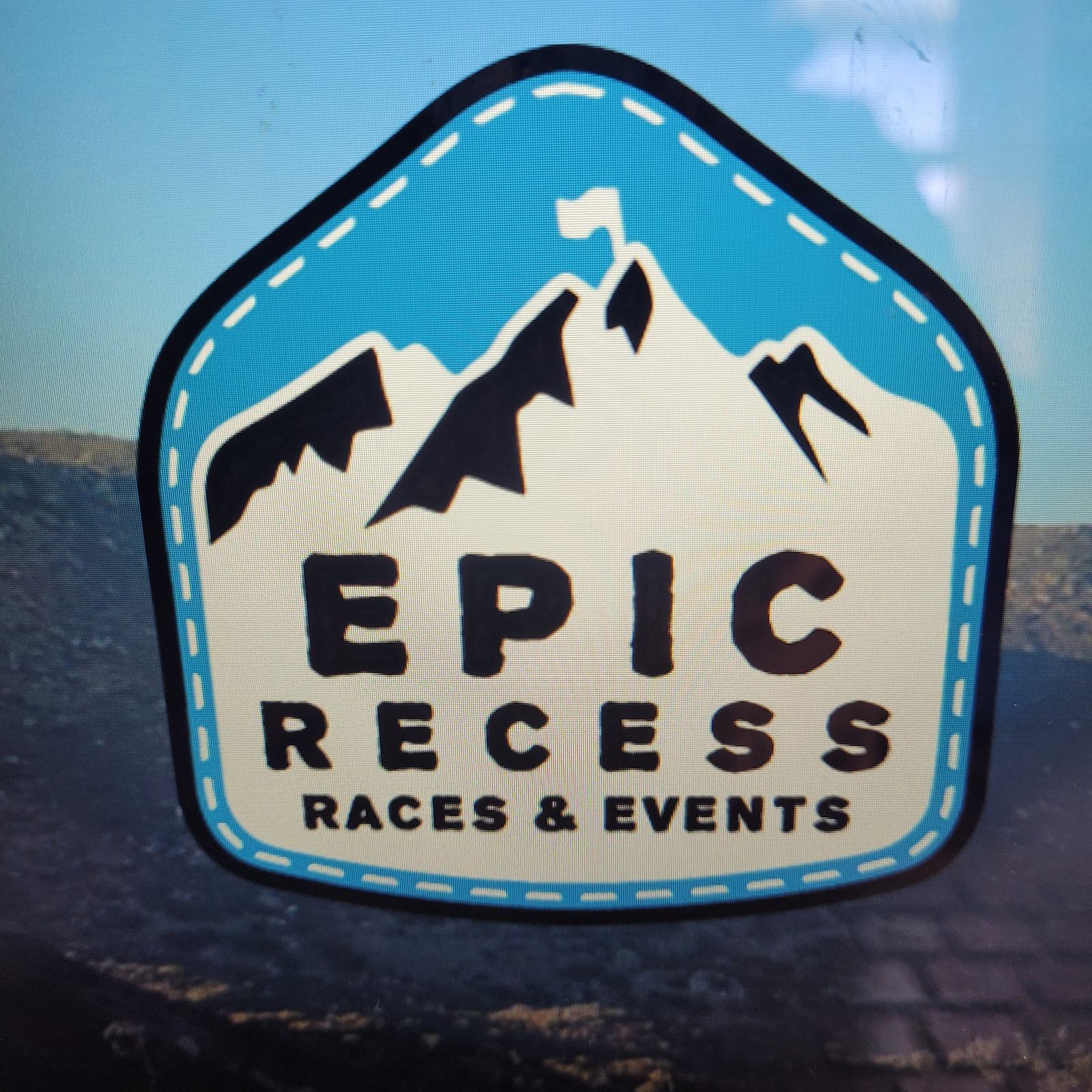 Logo for "Epic Races & Events" featuring stylized mountains with a flag on top, against a blue, shield-shaped background. The text "EPIC RECESS" is prominently displayed in bold letters.